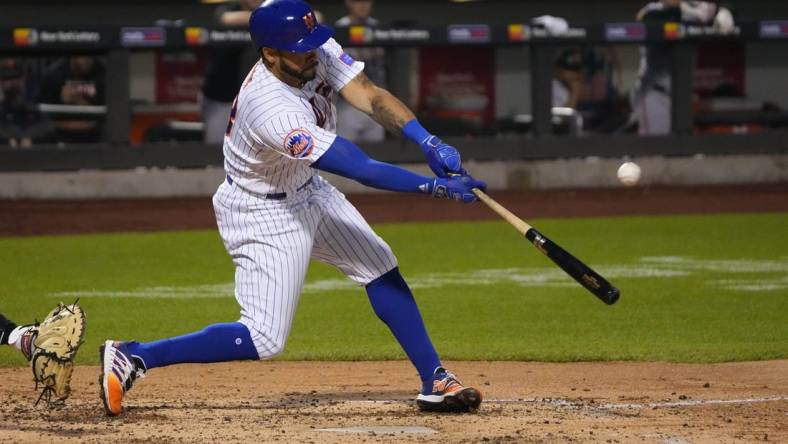 Jul 2, 2023; New York City, New York, USA; New York Mets left fielder Tommy Pham (28) hits an RBI double against the San Francisco Giants during the fourth inning at Citi Field. Mandatory Credit: Gregory Fisher-USA TODAY Sports