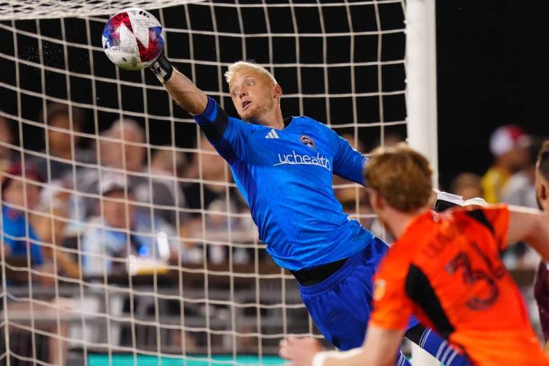 Jul 15, 2023; Commerce City, Colorado, USA; Colorado Rapids goalkeeper William Yarbrough (22) makes an incredible save against the Houston Dynamo FC during the second half at Dick's Sporting Goods Park. Mandatory Credit: Ron Chenoy-USA TODAY Sports