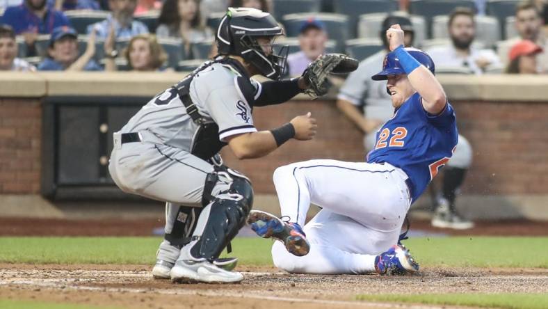 Jul 19, 2023; New York City, New York, USA;  New York Mets third baseman Brett Baty (22) slides safely past Chicago White Sox catcher Carlos Perez (36) in the fourth inning at Citi Field. Mandatory Credit: Wendell Cruz-USA TODAY Sports