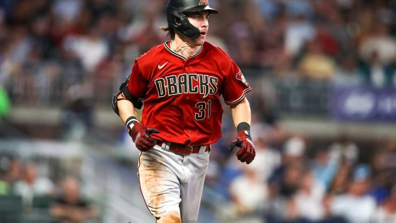 Jul 19, 2023; Atlanta, Georgia, USA; Arizona Diamondbacks right fielder Jake McCarthy (31) hits a single against the Atlanta Braves in the ninth inning at Truist Park. Mandatory Credit: Brett Davis-USA TODAY Sports