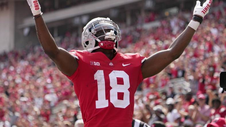 September 10, 2022; Columbus, Ohio, USA; Ohio State Buckeyes wide receiver Marvin Harrison Jr. (18) celebrates after scoring a touchdown during the second half of Saturday's game against the Arkansas State Red Wolves at Ohio Stadium.Mandatory Credit: Barbara J. Perenic/Columbus Dispatch