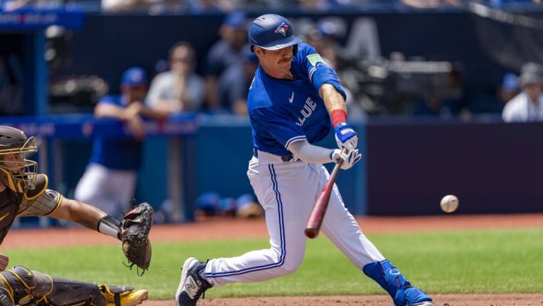 Jul 20, 2023; Toronto, Ontario, CAN; Toronto Blue Jays left fielder Jordan Luplow (7) hits a RBI single against the San Diego Padres during the second inning at Rogers Centre. Mandatory Credit: Kevin Sousa-USA TODAY Sports