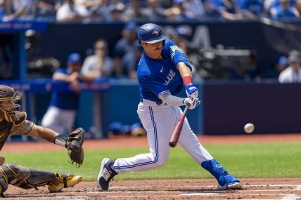 Jul 20, 2023; Toronto, Ontario, CAN; Toronto Blue Jays left fielder Jordan Luplow (7) hits a RBI single against the San Diego Padres during the second inning at Rogers Centre. Mandatory Credit: Kevin Sousa-USA TODAY Sports