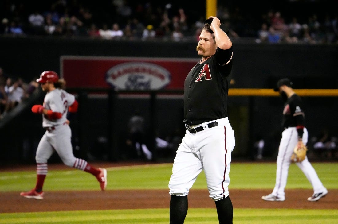Jul 24, 2023; Phoenix, AZ, USA; Arizona Diamondbacks relief pitcher Andrew Chafin (57) reacts after walking in the winning run against the St. Louis Cardinals in the ninth inning at Chase Field. Mandatory Credit: Rob Schumacher-Arizona Republic