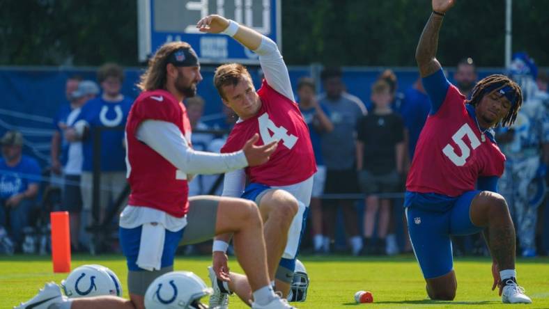 Indianapolis Colts quarterbacks Gardner Minshew (10), Sam Ehlinger (4), and Anthony Richardson (5) stretch before the first day of training camp practice Wednesday, July 26, 2023, at Grand Park Sports Complex in Westfield, Indiana.