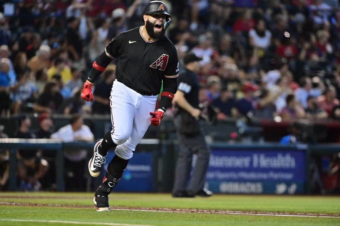 Jul 26, 2023; Phoenix, Arizona, USA;  Arizona Diamondbacks third baseman Emmanuel Rivera (15) hits a solo home run in the sixth inning against the St. Louis Cardinals at Chase Field. Mandatory Credit: Matt Kartozian-USA TODAY Sports