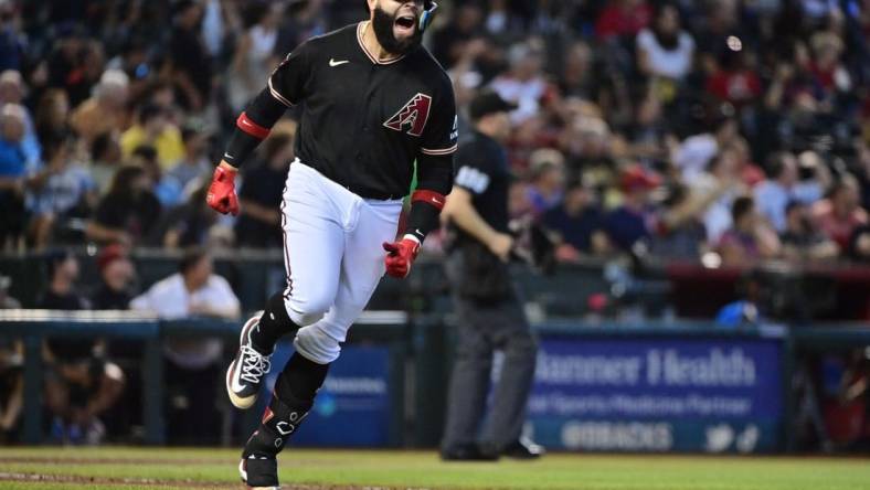 Jul 26, 2023; Phoenix, Arizona, USA;  Arizona Diamondbacks third baseman Emmanuel Rivera (15) hits a solo home run in the sixth inning against the St. Louis Cardinals at Chase Field. Mandatory Credit: Matt Kartozian-USA TODAY Sports