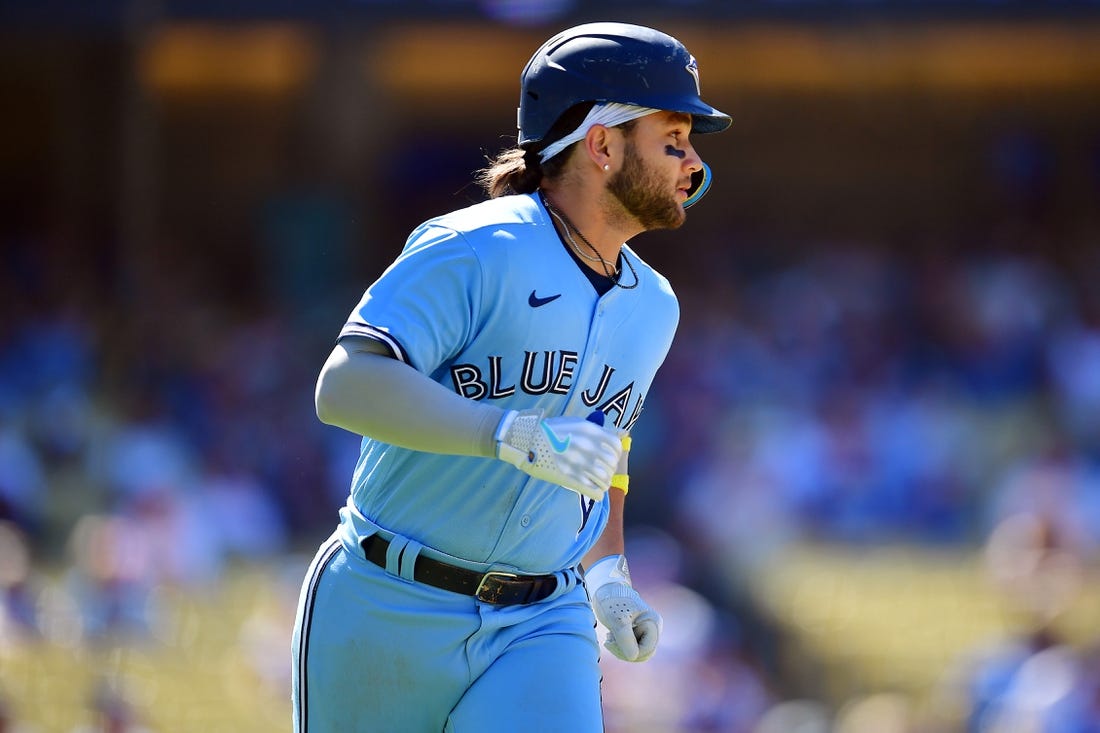 Jul 26, 2023; Los Angeles, California, USA; Toronto Blue Jays shortstop Bo Bichette (11) runs after hitting a two run RBI single against the Los Angeles Dodgers during the eighth inning at Dodger Stadium. Mandatory Credit: Gary A. Vasquez-USA TODAY Sports