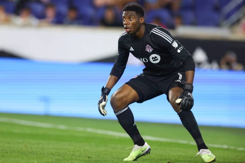 Jul 26, 2023; Harrison, NJ, USA; Toronto FC goalkeeper Sean Johnson (1) sets for a shot during the second half against New York City FC at Red Bull Arena. Mandatory Credit: Vincent Carchietta-USA TODAY Sports