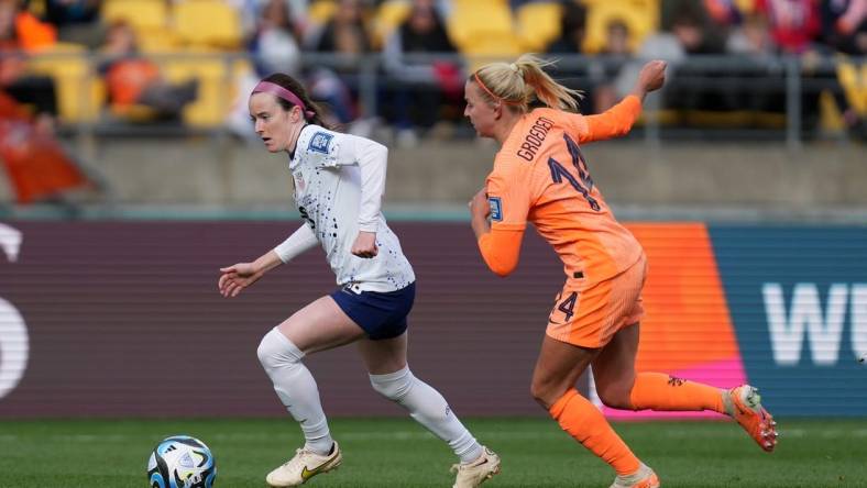 Jul 27, 2023; Wellington, NZL; United States midfielder Rose Lavelle (16) kicks the ball past Netherlands midfielder Jackie Groenen (14) during the second half in a group stage match for the 2023 FIFA Women's World Cup at Wellington Regional Stadium. Mandatory Credit: Jenna Watson-USA TODAY Sports