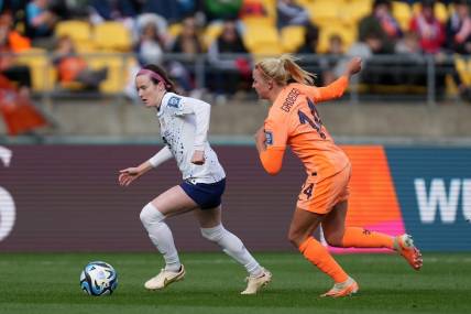 Jul 27, 2023; Wellington, NZL; United States midfielder Rose Lavelle (16) kicks the ball past Netherlands midfielder Jackie Groenen (14) during the second half in a group stage match for the 2023 FIFA Women's World Cup at Wellington Regional Stadium. Mandatory Credit: Jenna Watson-USA TODAY Sports