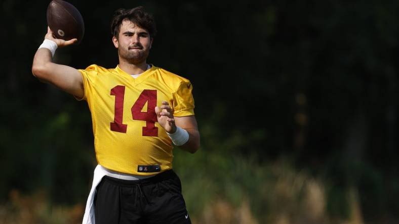 Jul 28, 2023; Ashburn, VA, USA; Washington Commanders quarterback Sam Howell (14) passes the ball on day three of Commanders training camp at OrthoVirginia Training Center. Mandatory Credit: Geoff Burke-USA TODAY Sports