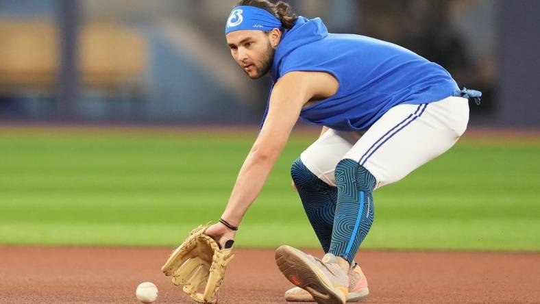 Jul 31, 2023; Toronto, Ontario, CAN; Toronto Blue Jays shortstop Bo Bichette (11) fields balls during batting practice before a game against the Baltimore Orioles at Rogers Centre. Mandatory Credit: Nick Turchiaro-USA TODAY Sports