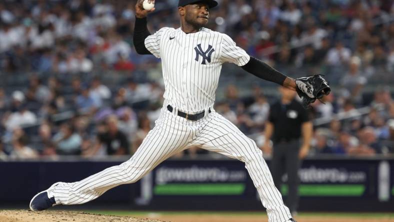 Jul 31, 2023; Bronx, New York, USA; New York Yankees starting pitcher Domingo German (0) delivers a pitch during the seventh inning against the Tampa Bay Rays at Yankee Stadium. Mandatory Credit: Vincent Carchietta-USA TODAY Sports