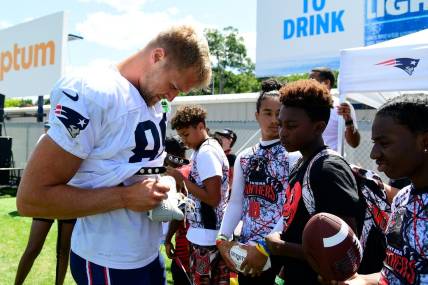Aug 1, 2023; Foxborough, MA, USA; New England Patriots tight end Mike Gesicki (88) signs an autograph for a fan at training camp at Gillette Stadium. Mandatory Credit: Eric Canha-USA TODAY Sports