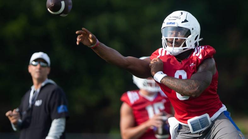 Kansas junior quarterback Jalon Daniels (6) practices passes during Tuesday's outdoor practice.