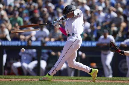 Aug 2, 2023; Seattle, Washington, USA; Seattle Mariners  Julio Rodriguez breaks his bat hitting an RBI single against the Boston Red Sox suring the seventh inning at T-Mobile Park. Mandatory Credit: John Froschauer-USA TODAY Sports