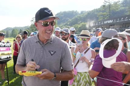 Aug 4, 2023; White Sulphur Springs, West Virginia, USA; Phil Mickelson signs autographs after the first round of the LIV Golf event at The Old White Course. Mandatory Credit: Bob Donnan-USA TODAY Sports