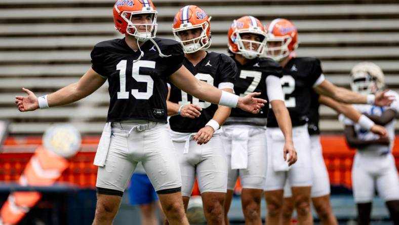 Florida Gators quarterback Graham Mertz (15) stretches with Florida Gators quarterback Jack Miller III (10) and Florida Gators quarterback Max Brown (17) during fall football practice at Ben Hill Griffin Stadium at the University of Florida in Gainesville, FL on Saturday, August 5, 2023. [Matt Pendleton/Gainesville Sun]