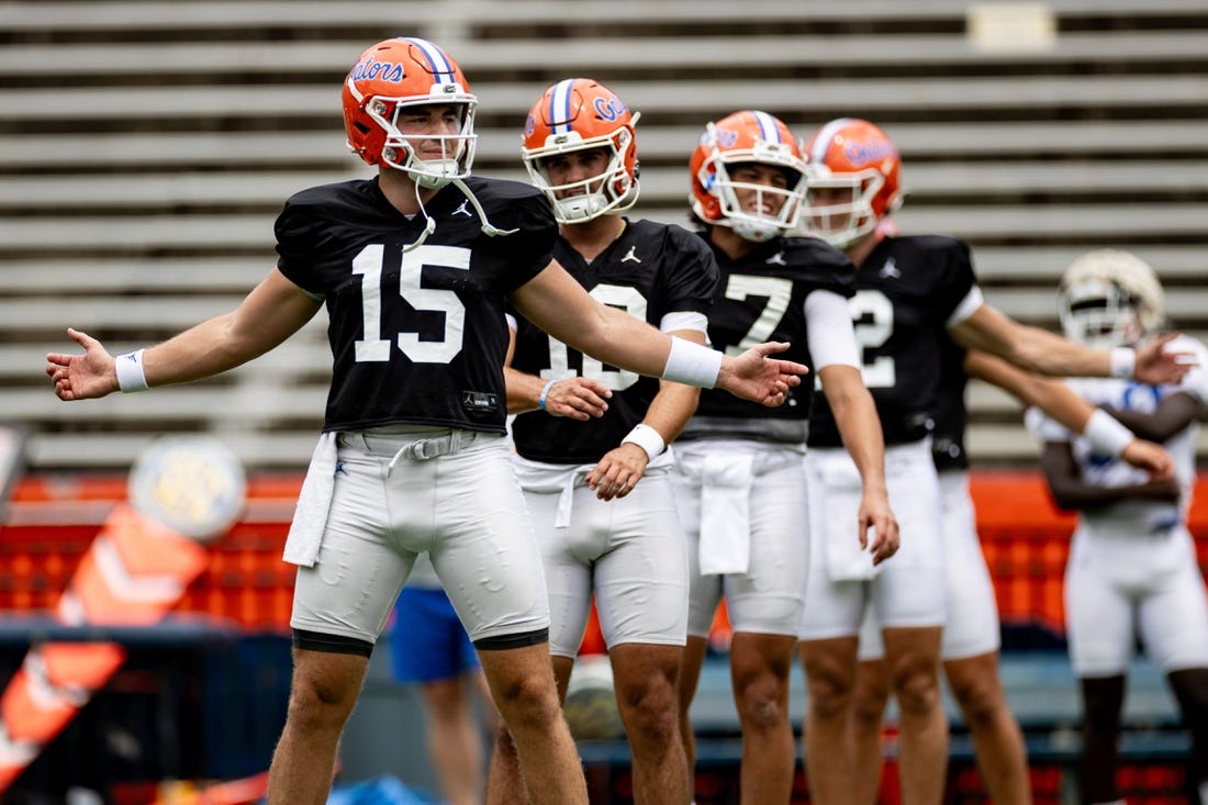 Florida Gators quarterback Graham Mertz (15) stretches with Florida Gators quarterback Jack Miller III (10) and Florida Gators quarterback Max Brown (17) during fall football practice at Ben Hill Griffin Stadium at the University of Florida in Gainesville, FL on Saturday, August 5, 2023. [Matt Pendleton/Gainesville Sun]