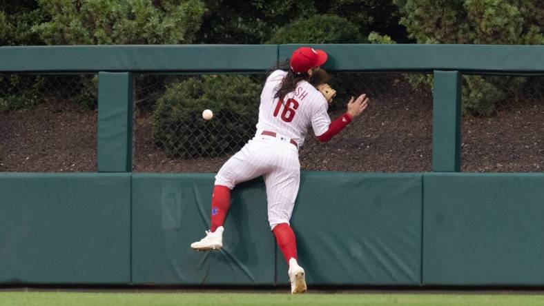 Aug 5, 2023; Philadelphia, Pennsylvania, USA; Philadelphia Phillies center fielder Brandon Marsh (16) is injured while attempting to catch the triple of Kansas City Royals second baseman Samad Taylor (not pictured) during the fifth inning at Citizens Bank Park. Mandatory Credit: Bill Streicher-USA TODAY Sports