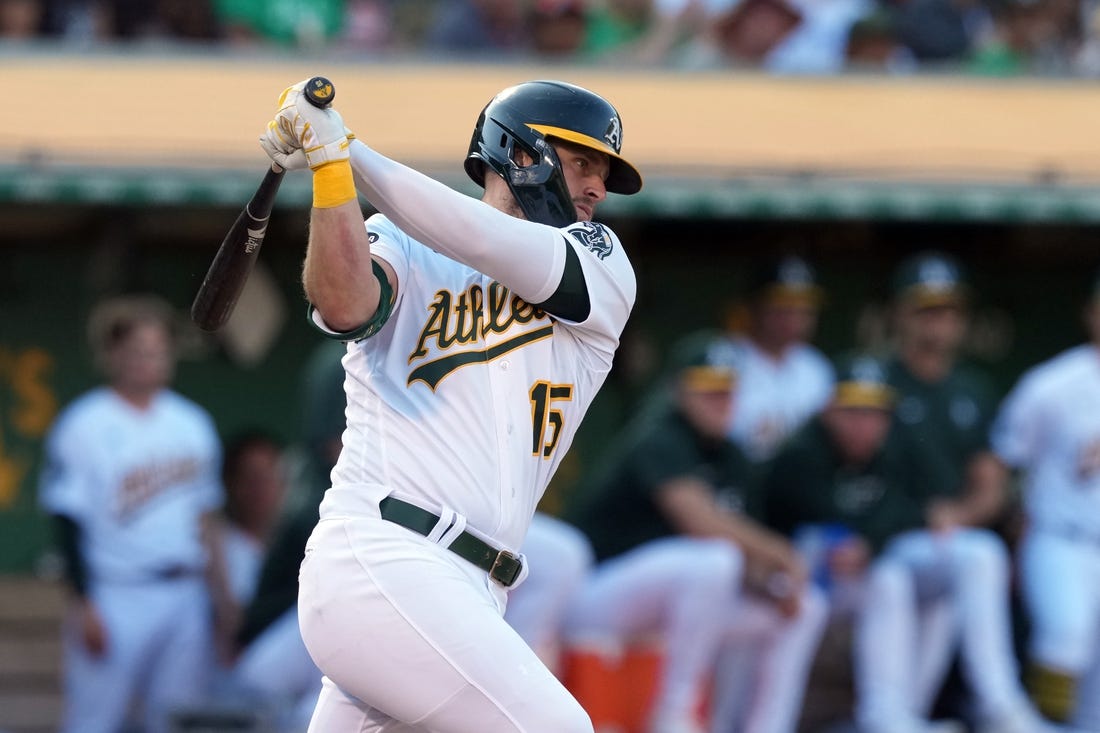 Aug 5, 2023; Oakland, California, USA; Oakland Athletics right fielder Seth Brown (15) hits an RBI single against the San Francisco Giants during the eighth inning at Oakland-Alameda County Coliseum. Mandatory Credit: Darren Yamashita-USA TODAY Sports