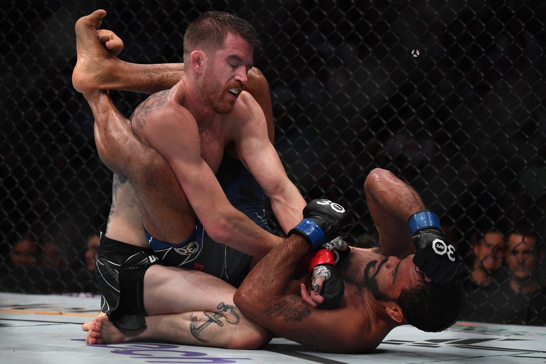 Aug 5, 2023; Nashville, Tennessee, USA;  Cory Sandhagen (red gloves) fights Rob Font (blue gloves) during UFC Fight Night at Bridgestone Arena. Mandatory Credit: Christopher Hanewinckel-USA TODAY Sports