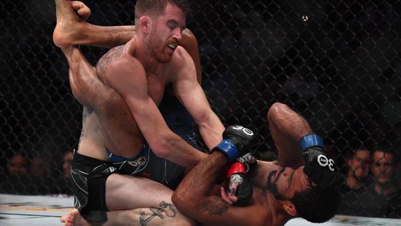 Aug 5, 2023; Nashville, Tennessee, USA;  Cory Sandhagen (red gloves) fights Rob Font (blue gloves) during UFC Fight Night at Bridgestone Arena. Mandatory Credit: Christopher Hanewinckel-USA TODAY Sports