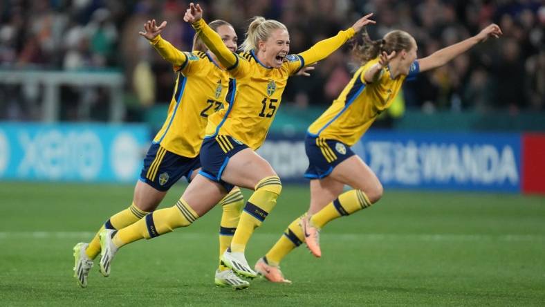 Aug 6, 2023; Melbourne, AUS; Sweden forward Rebecka Blomqvist (15), midfielder Elin Rubensson (23) and defender Magdalena Eriksson (6) celebrate after forward Lina Hurtig (not pictured) scored the winning goal against the United States in the penalty kick shootout during a Round of 16 match in the 2023 FIFA Women's World Cup at Melbourne Rectangular Stadium. Mandatory Credit: Jenna Watson-USA TODAY Sports