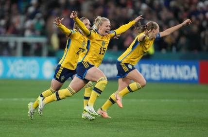 Aug 6, 2023; Melbourne, AUS; Sweden forward Rebecka Blomqvist (15), midfielder Elin Rubensson (23) and defender Magdalena Eriksson (6) celebrate after forward Lina Hurtig (not pictured) scored the winning goal against the United States in the penalty kick shootout during a Round of 16 match in the 2023 FIFA Women's World Cup at Melbourne Rectangular Stadium. Mandatory Credit: Jenna Watson-USA TODAY Sports