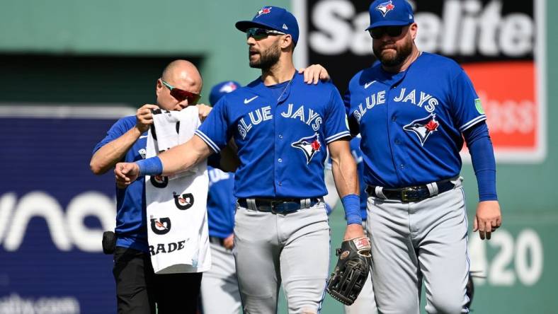 Aug 6, 2023; Boston, Massachusetts, USA; Toronto Blue Jays center fielder Kevin Kiermaier (39) gets medical attention to his left arm during the sixth inning against the Boston Red Sox at Fenway Park. Mandatory Credit: Eric Canha-USA TODAY Sports