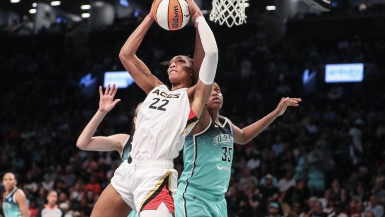 Aug 6, 2023; Brooklyn, New York, USA; Las Vegas Aces forward A'ja Wilson (22) grabs a rebound in front of New York Liberty forward Jonquel Jones (35) in the third quarter at Barclays Center. Mandatory Credit: Wendell Cruz-USA TODAY Sports