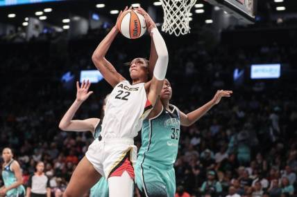 Aug 6, 2023; Brooklyn, New York, USA; Las Vegas Aces forward A'ja Wilson (22) grabs a rebound in front of New York Liberty forward Jonquel Jones (35) in the third quarter at Barclays Center. Mandatory Credit: Wendell Cruz-USA TODAY Sports