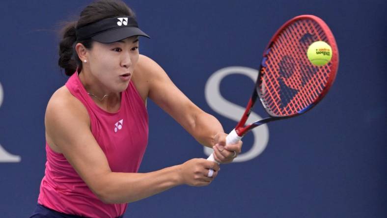 Aug 7, 2023; Montreal, Quebec, Canada; Lin Zhu (CHN) hits a backhand against Karolina Pliskova (CZE) in first round play at IGA Stadium. Mandatory Credit: Eric Bolte-USA TODAY Sports