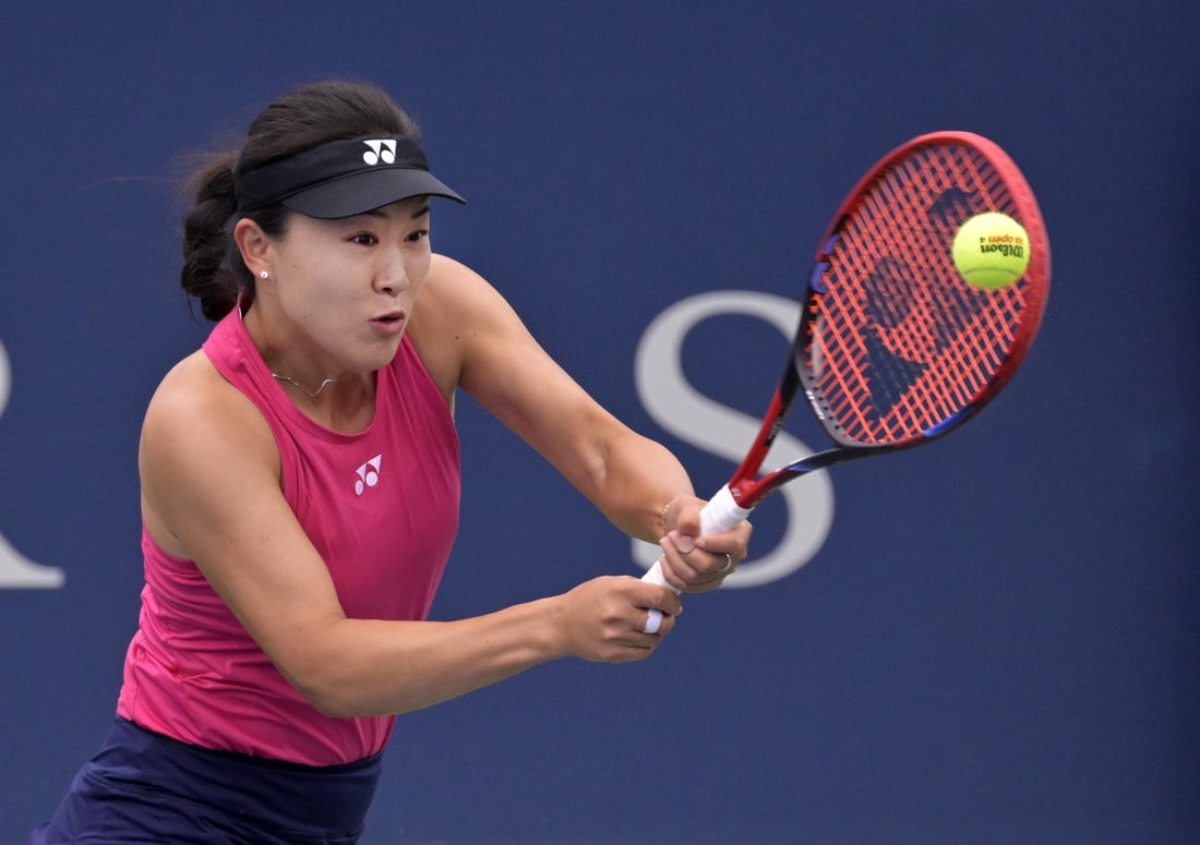 Aug 7, 2023; Montreal, Quebec, Canada; Lin Zhu (CHN) hits a backhand against Karolina Pliskova (CZE) in first round play at IGA Stadium. Mandatory Credit: Eric Bolte-USA TODAY Sports