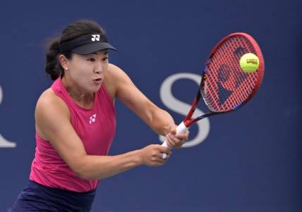 Aug 7, 2023; Montreal, Quebec, Canada; Lin Zhu (CHN) hits a backhand against Karolina Pliskova (CZE) in first round play at IGA Stadium. Mandatory Credit: Eric Bolte-USA TODAY Sports