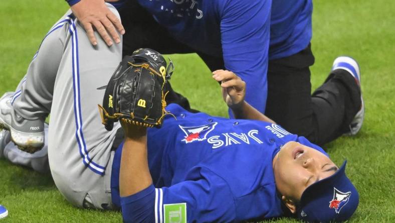 Aug 7, 2023; Cleveland, Ohio, USA; Toronto Blue Jays starting pitcher Hyun Jin Ryu (99) reacts after he was hit by a batted ball in the fourth inning against the Cleveland Guardians at Progressive Field. Mandatory Credit: David Richard-USA TODAY Sports