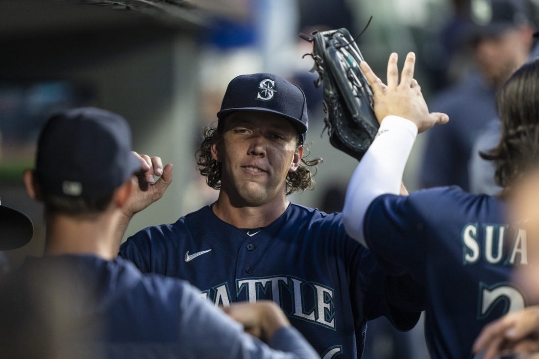 Aug 8, 2023; Seattle, Washington, USA; Seattle Mariners starting pitcher Logan Gilbert (36) is congratulated by teammates in the dugout during the seventh inning against the San Diego Padres at T-Mobile Park. Mandatory Credit: Stephen Brashear-USA TODAY Sports