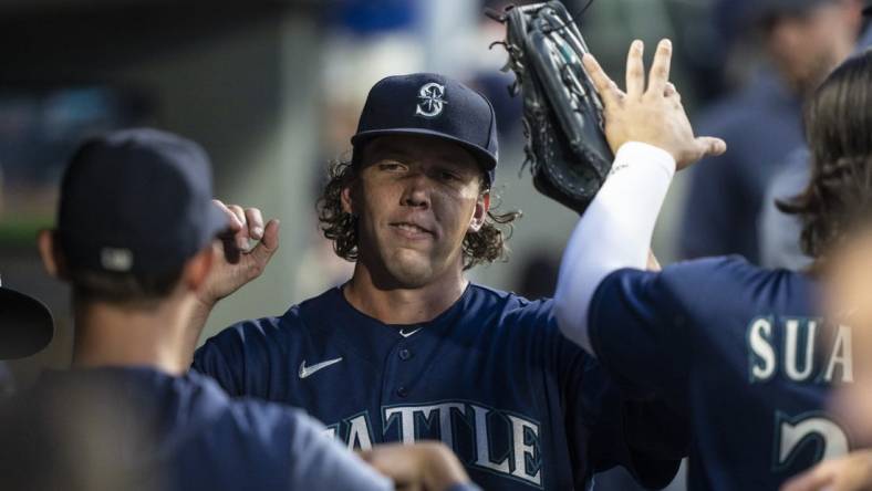 Aug 8, 2023; Seattle, Washington, USA; Seattle Mariners starting pitcher Logan Gilbert (36) is congratulated by teammates in the dugout during the seventh inning against the San Diego Padres at T-Mobile Park. Mandatory Credit: Stephen Brashear-USA TODAY Sports