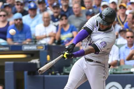 Aug 9, 2023; Milwaukee, Wisconsin, USA; Colorado Rockies designated hitter Jurickson Profar (29) hits a solo home run against the Milwaukee Brewers in the fourth inning at American Family Field. Mandatory Credit: Benny Sieu-USA TODAY Sports