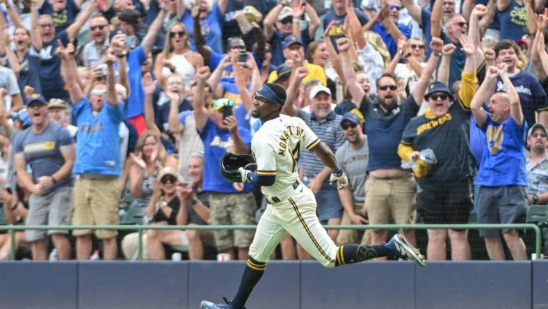 Aug 9, 2023; Milwaukee, Wisconsin, USA; Milwaukee Brewers third baseman Andruw Monasterio (14) and fans celebrate after beating the Colorado Rockies at American Family Field. Mandatory Credit: Benny Sieu-USA TODAY Sports