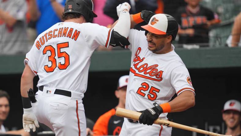 Aug 10, 2023; Baltimore, Maryland, USA; Baltimore Orioles designated hitter Adley Rutschman (35) is greeted by outfielder Anthony Santander (25) following his solo home run in the first inning against the Houston Astros at Oriole Park at Camden Yards. Mandatory Credit: Mitch Stringer-USA TODAY Sports