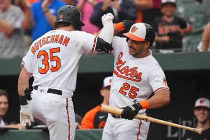 Aug 10, 2023; Baltimore, Maryland, USA; Baltimore Orioles designated hitter Adley Rutschman (35) is greeted by outfielder Anthony Santander (25) following his solo home run in the first inning against the Houston Astros at Oriole Park at Camden Yards. Mandatory Credit: Mitch Stringer-USA TODAY Sports