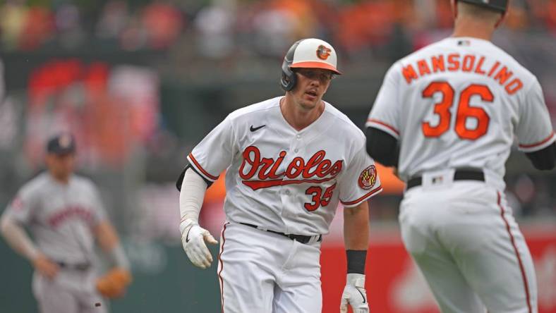 Aug 10, 2023; Baltimore, Maryland, USA; Baltimore Orioles designated hitter Adley Rutschman (35) is greeted by coach Tony Mansolino (36) following his solo home run in the first inning against the Houston Astros at Oriole Park at Camden Yards. Mandatory Credit: Mitch Stringer-USA TODAY Sports