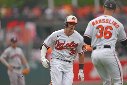Aug 10, 2023; Baltimore, Maryland, USA; Baltimore Orioles designated hitter Adley Rutschman (35) is greeted by coach Tony Mansolino (36) following his solo home run in the first inning against the Houston Astros at Oriole Park at Camden Yards. Mandatory Credit: Mitch Stringer-USA TODAY Sports