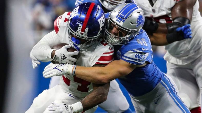 Detroit Lions linebacker Jack Campbell (46) tackles New York Giants running back James Robinson (24) during the first half of a preseason game at Ford Field in Detroit on Friday, Aug. 11, 2023.