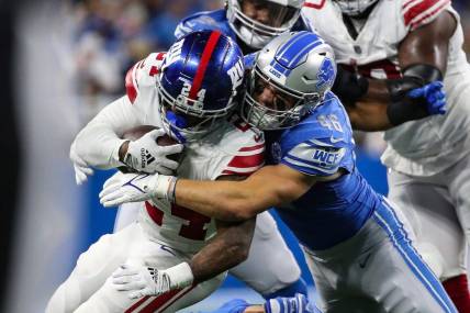 Detroit Lions linebacker Jack Campbell (46) tackles New York Giants running back James Robinson (24) during the first half of a preseason game at Ford Field in Detroit on Friday, Aug. 11, 2023.