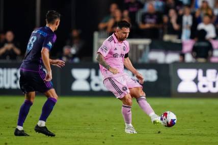 Aug 11, 2023; Fort Lauderdale, FL, USA; Inter Miami CF forward Lionel Messi (10) plays the ball as Charlotte FC midfielder Ashley Westwood (8) defends in the first half at DRV PNK Stadium. Mandatory Credit: John David Mercer-USA TODAY Sports