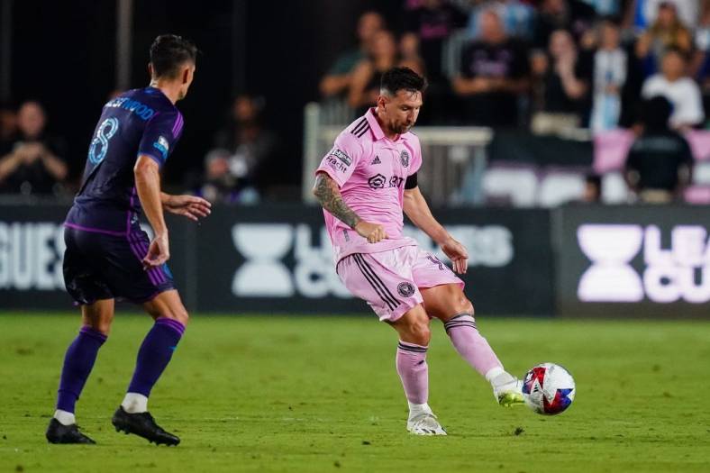 Aug 11, 2023; Fort Lauderdale, FL, USA; Inter Miami CF forward Lionel Messi (10) plays the ball as Charlotte FC midfielder Ashley Westwood (8) defends in the first half at DRV PNK Stadium. Mandatory Credit: John David Mercer-USA TODAY Sports