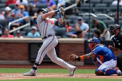 Aug 12, 2023; New York City, New York, USA; Atlanta Braves third baseman Austin Riley (27) follows through on an RBI single against the New York Mets during the first inning at Citi Field. Mandatory Credit: Brad Penner-USA TODAY Sports